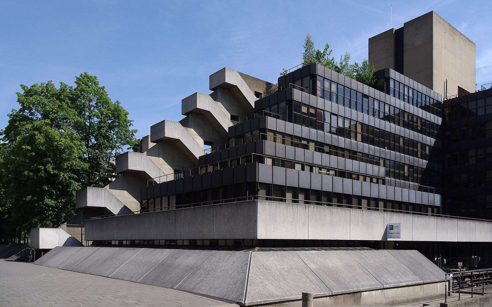 Zigzag concrete staircases descend the brutalist facade of the University of London Institute of Education